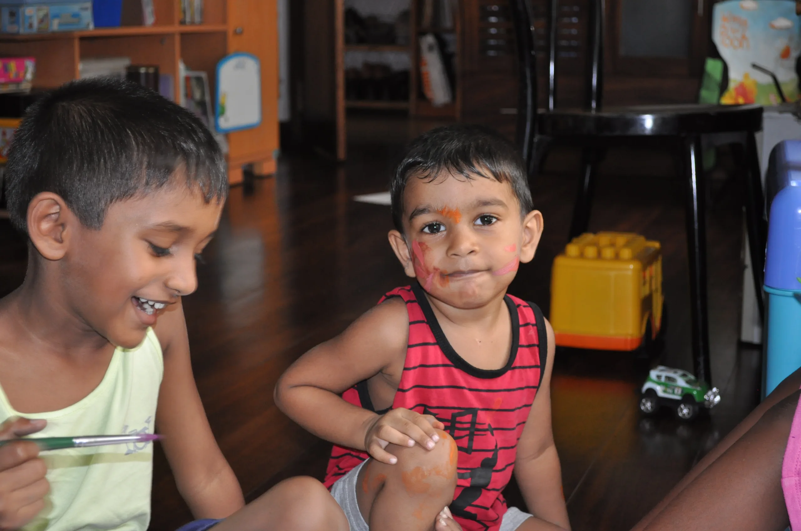 Two children taking part in a face-painting activity