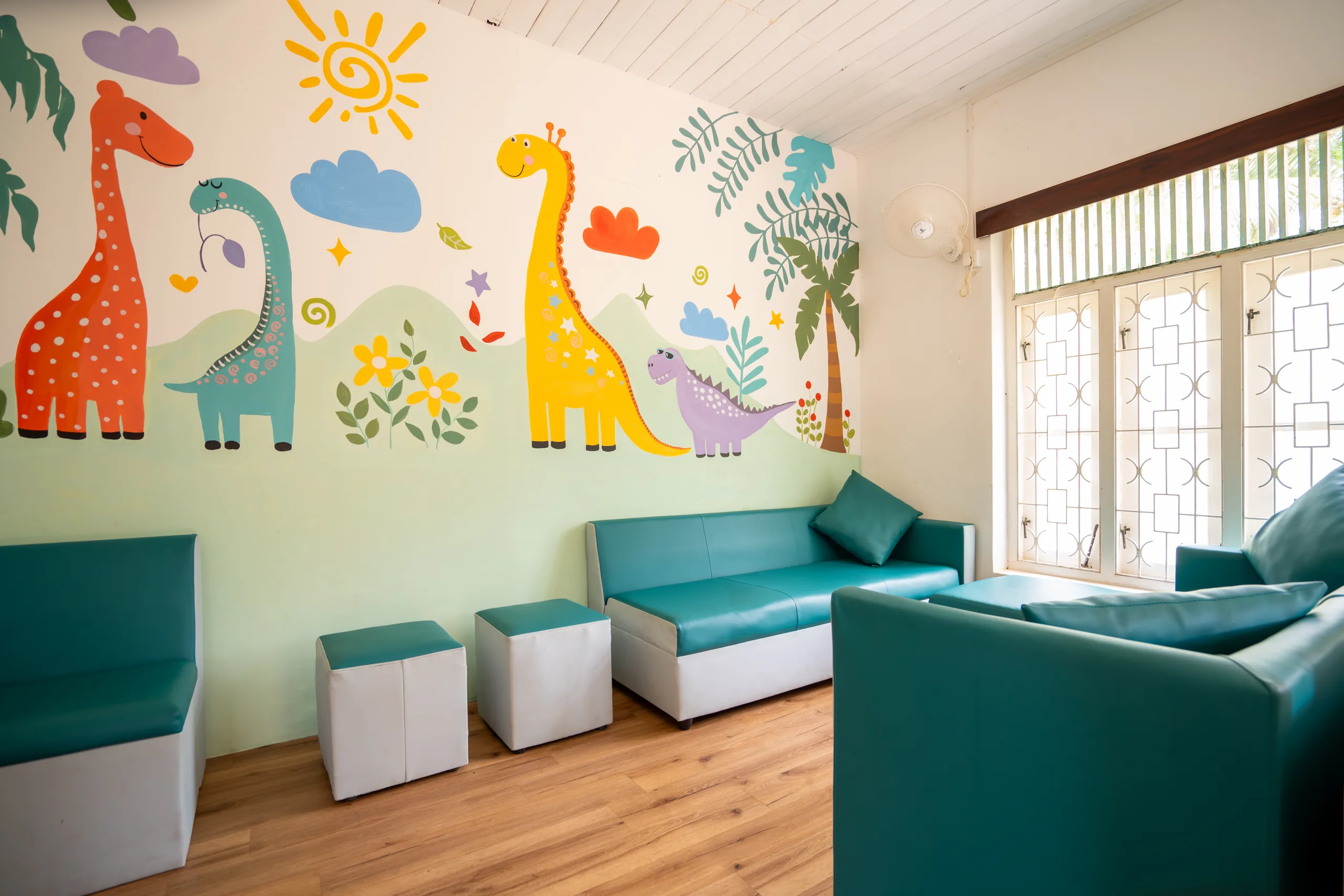 Waiting area with a dinosaur wall mural